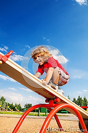 Walking over seesaw Stock Photo