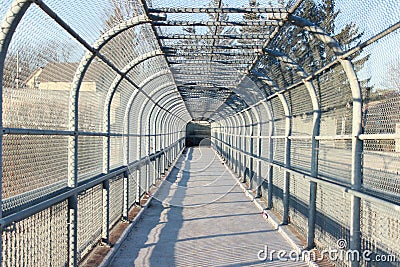 Enclosed walkway with chain link fence Stock Photo