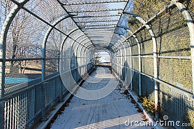 Enclosed walkway with chain link fence Stock Photo