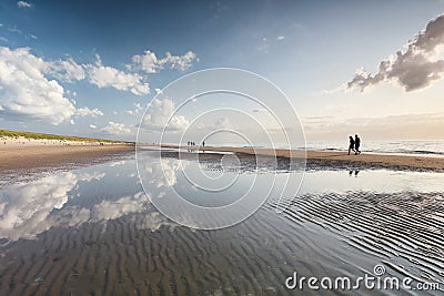 Walking people silhouettes on sand sea beach Editorial Stock Photo