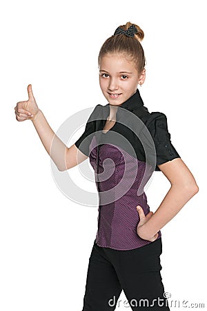 Walking preteen girl holds her thumb up Stock Photo