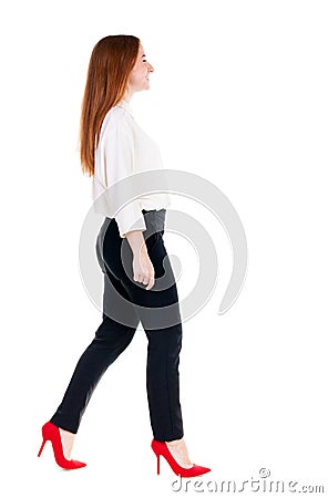 Walking redhead business woman. Stock Photo