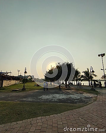 Walking through the road which leads to an amazing lakeside situated inside a park near a city Stock Photo