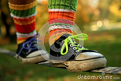 Walking the slackline in sneakers and colour socks Stock Photo