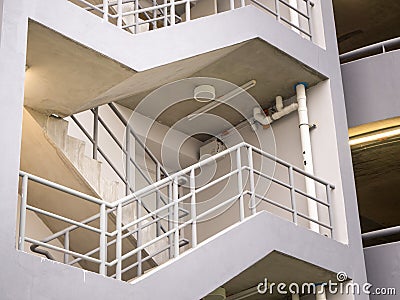 Walking stair on the side of a white multi storey parking lots building Stock Photo