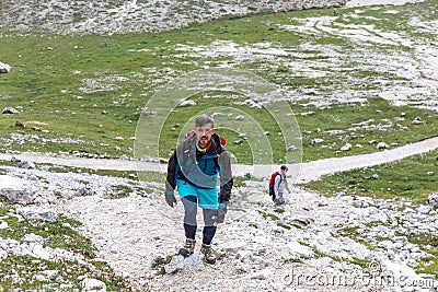 Walking summer trekking in the Dolomites. People in the mountains. Mountain view Italian Alps. Stock Photo