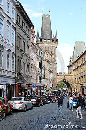 The walking tourists pass through an acre and come to Karlov Bridge. Editorial Stock Photo