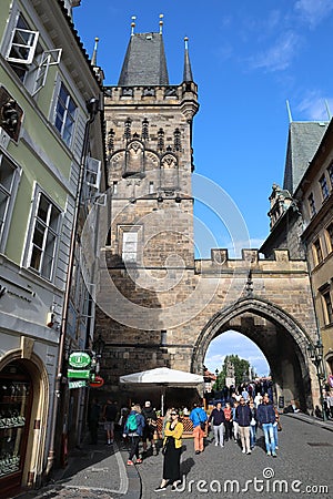 The walking tourists pass through an acre and come to Karlov Bridge. Editorial Stock Photo