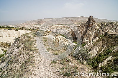 Walking trail through beautiful inspiring scenic panoramic stone mountain landscape view of red valley with sky background Stock Photo