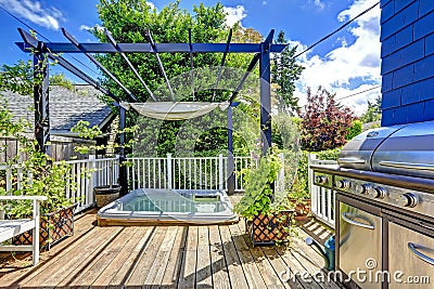 Walkout deck with jacuzzi and pergola. Stock Photo
