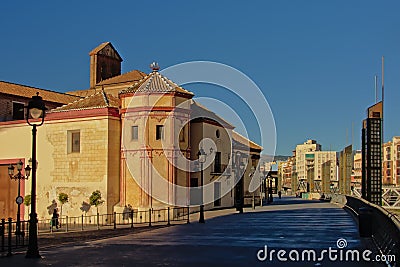 Walkway along river Guadalmedina with Santo Domingo church on a sunny day, Malaga, Spain Editorial Stock Photo