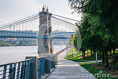 Walkway and the John A. Roebling Suspension Bridge, seen at Smale Riverfront Park, in Cincinnati, Ohio Editorial Stock Photo