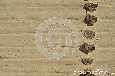 Wall of the antique rustic house made of wood beams, plastered Stock Photo