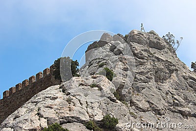 The wall of Genoese Fortress as a part of rock Stock Photo