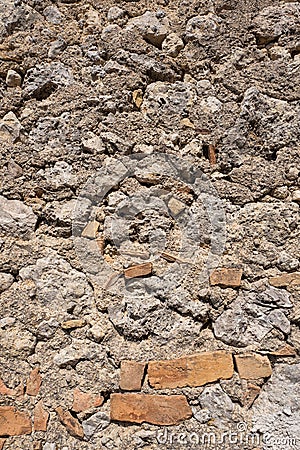 Wall with basalt blocks and bricks. Stock Photo