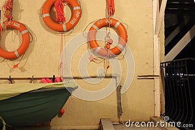 The wall of the boat station with lifebuoys at the sea pier Stock Photo