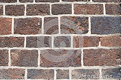 A wall consisting of hewn stone bonded with cement mortar Stock Photo