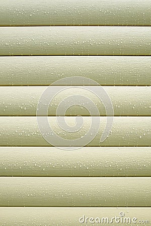 Wall covered with beige siding with many water drops after rain closeup as background Stock Photo