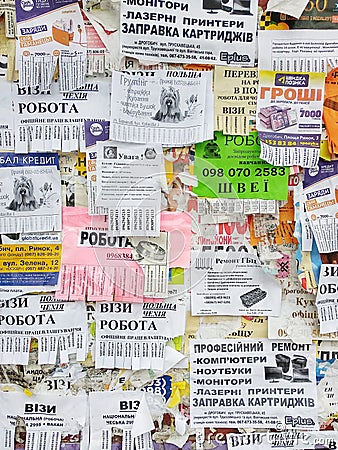 The wall is full of advertisements: offers of work and services, purchase of goods, information about events, advertising Editorial Stock Photo