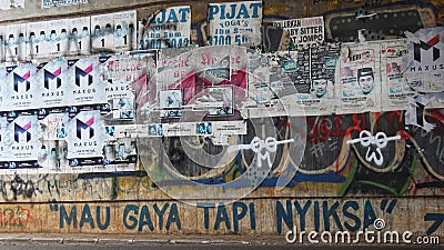 A wall full of grafitti and commercial poster Editorial Stock Photo