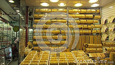 The wall of gold is the jeweler`s showcase in Dubai, the gold market Editorial Stock Photo