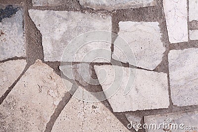 Wall with granite inserts background close-up. Stock photo wall facade with a granite daub Stock Photo