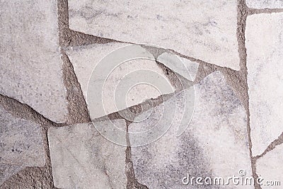 Wall with granite inserts background close-up. Stock photo wall facade with a granite daub Stock Photo