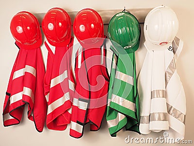 Wall hanger with vest and helmets for a emergency warden team Stock Photo