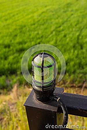 Wall lamp over green field background Stock Photo
