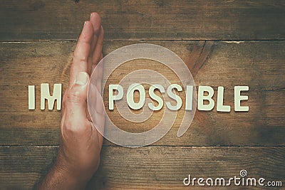 wall between of the letters IM from the word impossible Stock Photo
