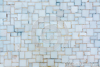 Wall lined with small bright ceramic or marble tiles, texture Stock Photo