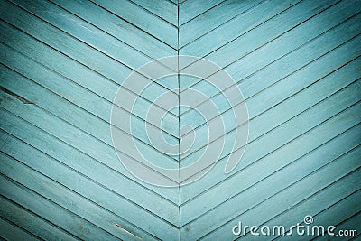 A wall made of diagonal slats. Bright green background with a texture of thin wooden boards. Stock Photo