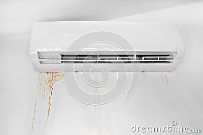 Wall with mold stain due to air conditioner leakage. Mildew stains and destruction of the wall. Stock Photo