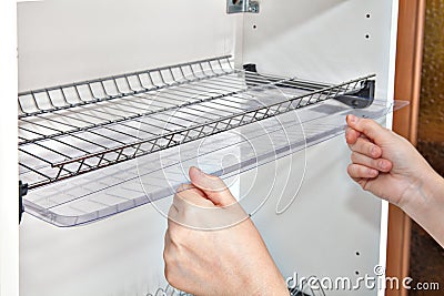 Wall mounted kitchen drying plate rack and shelf, kitchen storage. Stock Photo