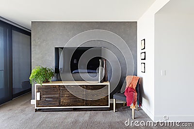 Wall mounted tv and buffet in spacious master bedroom Stock Photo