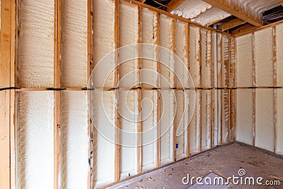 Wall in new home under construction, with spray foam insulation Stock Photo