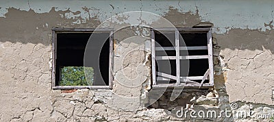 Wall of old blocks with a damaged wooden window without glass. Vintage village building Stock Photo