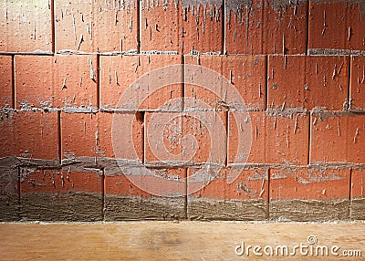 Wall of Porotherm style clay block bricks in a building under construction, background with copy space, lit laterally Stock Photo