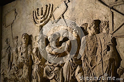 Wall relief on arch of titus depicting Menorah taken from temple in Jerusalem in 70 AD - Israel history, Jewish war Stock Photo