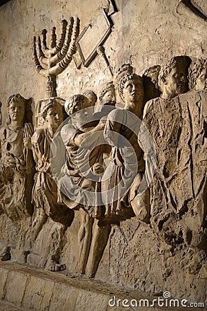 Wall relief on arch of titus depicting Menorah taken from temple in Jerusalem in 70 AD - Israel history, Jewish war Stock Photo