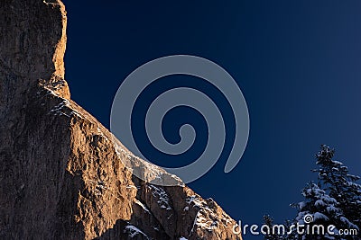 Wall of rock in winter close to Christmas Holiday with pine tree Stock Photo