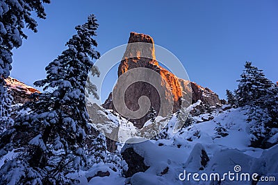 Wall of rock in winter close to Christmas Holiday with pine tree Stock Photo