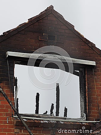 Wall of a ruined of a burned down residential building after a fire Stock Photo