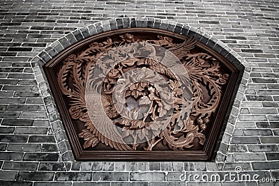 Wall Sculpture of two flying chinese swans surround with flowers Stock Photo