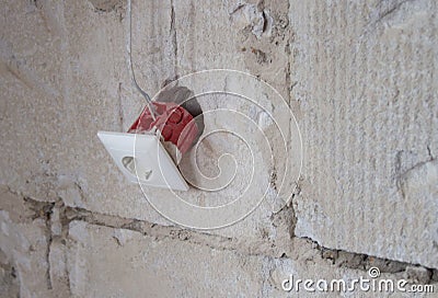 Wall socket installation and renovation, close up of old socket and wiring Stock Photo