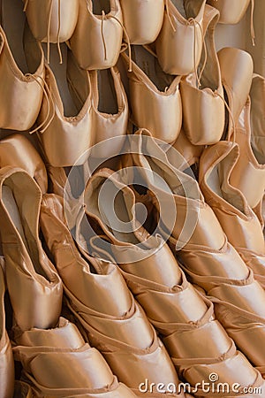 A Wall of Stacked Pink Satin Ballet Slippers Stock Photo
