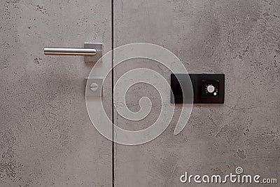 Wall temperature regulator located near the door to the room Stock Photo