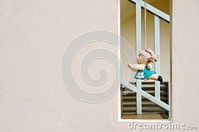 Wall texture with square Void and hanging clay doll Stock Photo