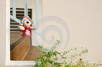 Wall texture with square Void and hanging clay doll Stock Photo