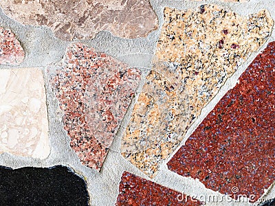 Wall from various polished granite pieces Stock Photo